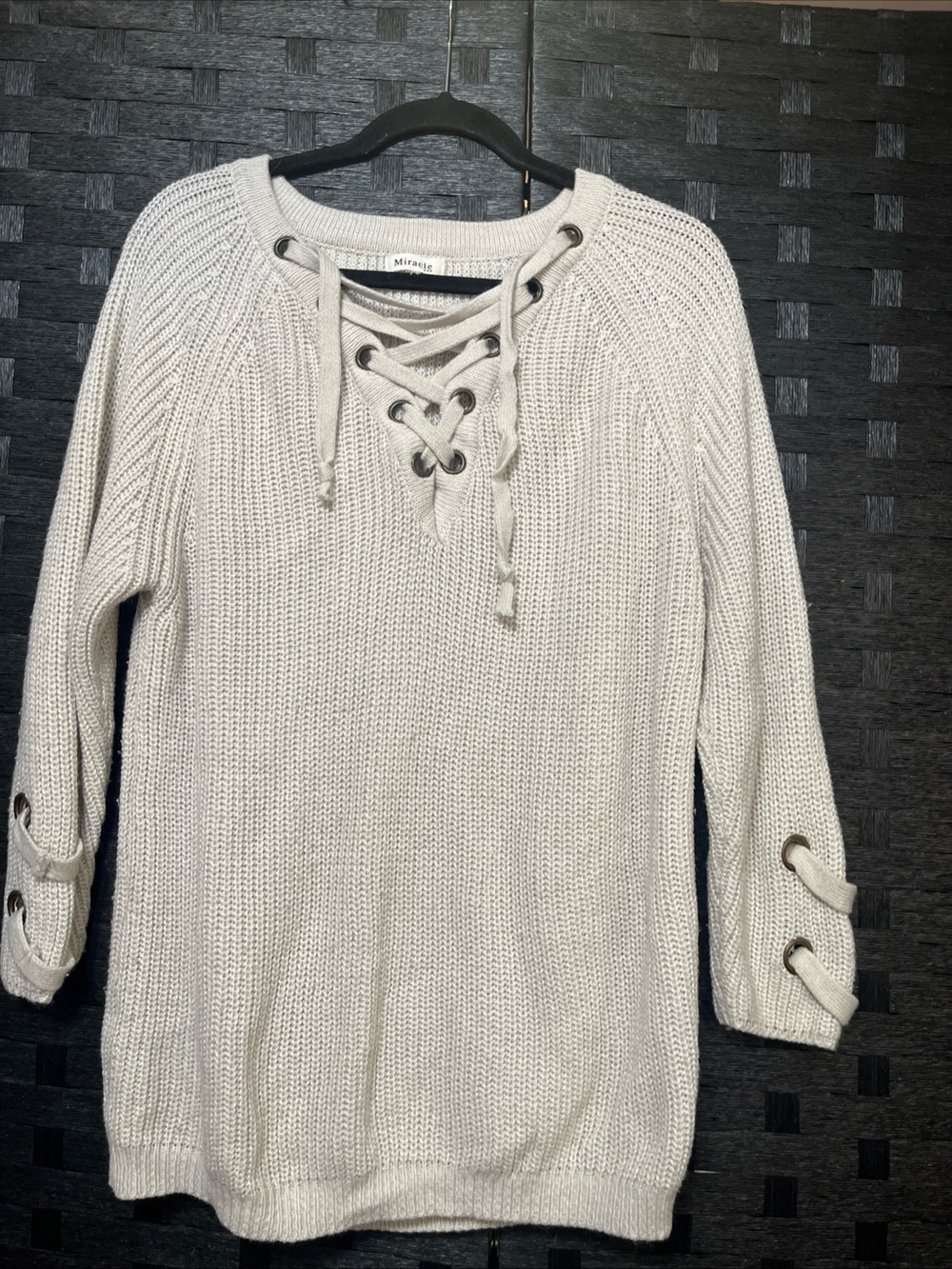 Women’s Miracle USA lace-up knit sweater featuring a grommet neckline Size L